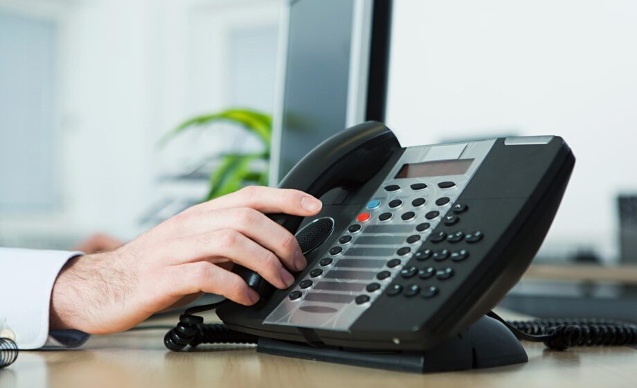 Una mano che sta prendendo un telefono con una chiamata per avere informazioni sul Numero Bianco fine vita